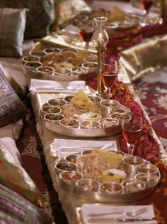 a long table filled with lots of food on top of it's trays