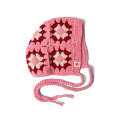 a crocheted pink and white purse on a white background