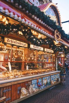 an outdoor food stand with lights and decorations