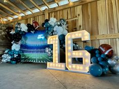 balloons and footballs are arranged in the shape of letters that spell out the number 16