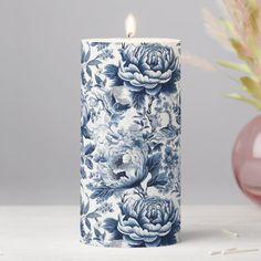 a blue and white candle sitting on top of a table