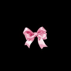 a pink bow on a black background