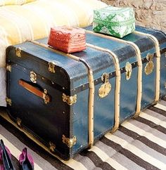 four pieces of luggage sitting on the floor next to each other in front of a bed