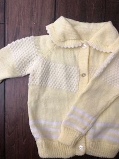 Sweet pale yellow knit cardigan Perfect for spring or Easter celebrations Measurements: sleeve length 12.5 in or 32.5 cm Approximately - 2T Cute Yellow Long Sleeve Sweater, Cute Fitted Cream Sweater, Fitted Cream Cute Sweater, Yellow Knitted Cardigan For Spring, Hand Knitted Yellow Sweater For Spring, Spring Yellow Knitted Cardigan, Spring Yellow Hand Knitted Sweater, Cute Cream Knitted Sweater, Yellow Retro Cardigan For Spring