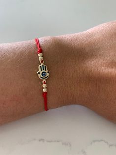 Unisex Red String Evil Protection Bracelet in Solid Gold, Stretchable    14K Gold Blue Evil Eye Bracelet, Hamsa Evil Eye Fancy Bracelet, Everyday Bracelet, Gold Bracelet, Statement Bracelet  ♦ Materials: 14K Gold ♦ Available colors: Gold and Blue, Diamond Cut Design  ♦ Evil Eye measurements: 9MM, 3MM beads are also genuine 14K gold, weights approx. .96 grams ♦ Hamsa measurements:  14x9MM, 3MM beads are also genuine 14K gold, weights approx. .80 grams If you need a big size, please advise on the Gold Evil Eye Bracelet, Fancy Bracelet, Hamsa Evil Eye, Bracelet Materials, Solid Gold Bracelet, Everyday Bracelet, Red String, Gold Armband, Blue Evil Eye