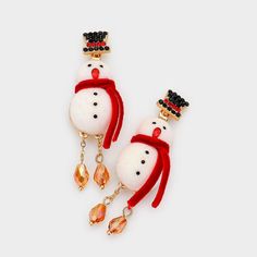 Add Some Sparkle And Joy To Your Winter Wardrobe With These Adorable Snowman Earrings. These Earrings Are Made Of Gold-Plated Metal And Feature A Cute Snowman Design With A Black Top Hat And Red Scarf. The Snowman’s Face Is Made Of Clear Crystals, While The Body Is Made Of White Enamel. The Earrings Are Also Accented With Dangling Teardrop-Shaped Crystals That Catch The Light Beautifully. These Earrings Are Perfect For Wearing To Holiday Parties, Family Gatherings, Or Any Festive Occasion. They Snowman Earrings, Holiday Accessories, Black Top Hat, Snowman Design, Tory Burch Earrings, Bling Wedding, Red Scarf, Flower Bag, Winter Themed