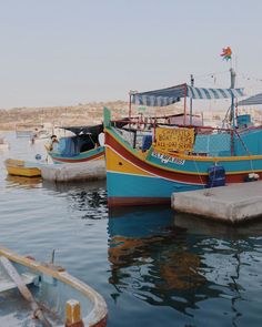 several boats are docked in the water near each other