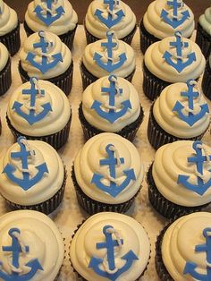 cupcakes decorated with blue and white frosting are arranged in rows on top of each other