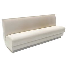 an upholstered white couch with no back cushions on the top and bottom part