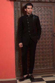 Black full sleeves bandhgala with Cosmo ray embroidery. Paired with a trouser. - Aza Fashions Traditional Fitted Bandhgala For Formal Occasions, Traditional Suits With Naqshi For Formal Occasions, Traditional Naqshi Suits For Formal Occasions, Traditional Tailored Sherwani For Semi-formal Occasions, Formal Fitted Dabka Bandhgala, Formal Fitted Bandhgala With Dabka, Formal Fitted Bandhgala With Dabka Details, Elegant Designer Suits For Festivals, Designer Tailored Bandhgala For Eid