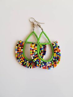 This listing is for ALL 9 pairs. The earrings are 100% handmade using original fine beads. Colorful and bright colors. ^^These earrings ships through dhl express. Buy multiple items and pay shipping for ONE item ONLY. Traditional Green Teardrop Beaded Earrings, Green Hoop Earrings With Colorful Beads, Green Beaded Earrings With Large Beads For Gift, Unique Green Beaded Earrings, Unique Multicolor Large Beads Earrings, Unique Multicolor Earrings With Large Beads, Multicolor Round Bead Earrings For Gifts, Unique Green Earrings With Colorful Beads, Green Dangle Hoop Earrings For Festival