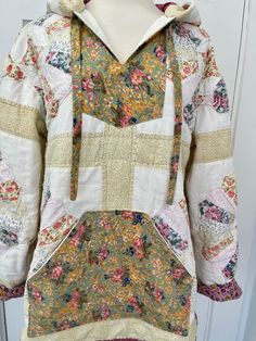 the back of a white jacket with multicolored flowers on it and a hoodie