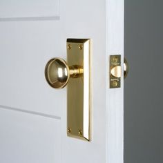 an open door with a brass handle and knobs on the outside side of it