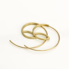 These are minimalist delicate gold hoop earrings, handmade of yellow 14k solid gold. I made these gold hoops of a rectangle gold wire, 2 mm wide x 1 mm thick. They have a delicate matte finish. Width of the delicate long ear wire (the wire that goes into the ear lobe) is 0.8 mm = about 0.3 inch.  These modern hoops are unique, and will add chic to any outfit. They are perfect for everyday's wear, as well as for a night out.  Elegant, minimal and eye catching. Total length of the earrings is 3.1 Modern Yellow Gold Plated Wrap Earrings, Minimalist Single Hoop Earring In Recycled Gold, Modern Yellow Gold Hoop Earrings In Recycled Gold, Minimalist Yellow Gold Hoop Earrings, Minimalist Yellow Gold Wrap Earrings As Gift, Modern Hoop Earrings In Recycled Gold, Yellow Gold Minimalist Hoop Earrings Gift, Minimalist Yellow Gold Hoop Wrap Earrings, Minimalist Yellow Gold Hoop Earrings Gift