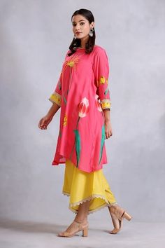 Pink kurta with floral pattern, highlighted with sequin and lace embroidery. Paired with a yellow draped pant. - Aza Fashions Festive Spring Bottoms With Printed Motifs, Traditional Floral Print Bottoms For Spring, Traditional Spring Floral Print Bottoms, Floral Print Bottoms For Spring Festivities, Spring Floral Print Festive Bottoms, Spring Festive Floral Print Bottoms, Floral Print Bottoms For Festive Spring Occasion, Yellow Drapes, Asymmetric Kurta