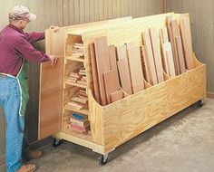 a man standing next to a large wooden box filled with boxes