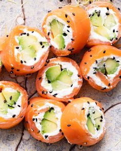 several pieces of sushi with cucumber and black sesame seeds on the top