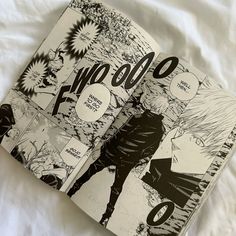 an open comic book sitting on top of a bed