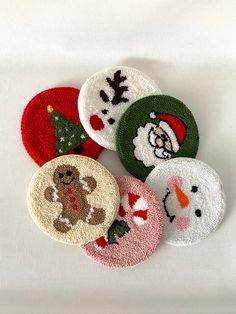 four christmas themed appliques are shown on a white surface