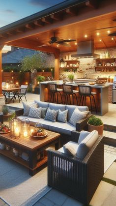 an outdoor living area with couches, tables and grill in the background at dusk