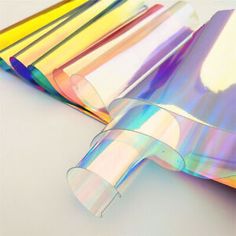 several different colored papers on a white surface