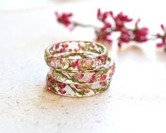 two wedding bands with pink flowers on them