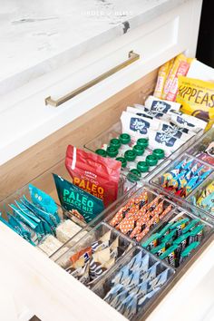 an organized drawer with snacks and candy