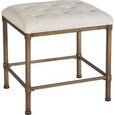 a white ottoman with metal legs and an upholstered cushion on the backrest