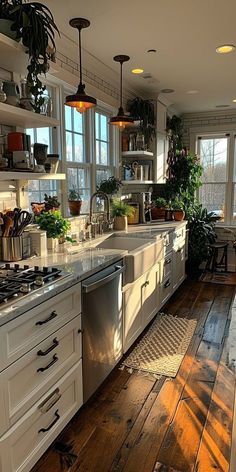 a kitchen filled with lots of white cabinets and counter top space next to a window