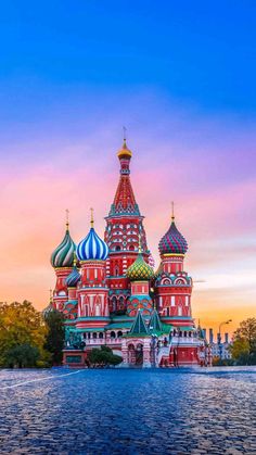 the cathedral is painted in red, white and blue with gold domes on it's sides