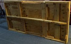 a large wooden shelf sitting on top of a carpeted floor