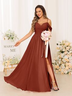 a woman in a long brown dress holding a bouquet and posing for the camera with her hand on her hip