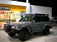 a grey suv parked in front of a store