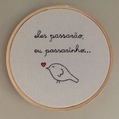 a white embroidered hoop with a bird and the words les passansneas eu passantinee on it