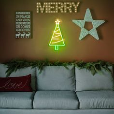 a living room with a christmas tree and star on the wall next to a couch