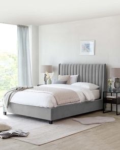 a bedroom with a large bed and two nightstands