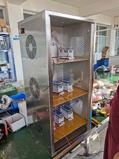 a man standing in front of a metal cabinet