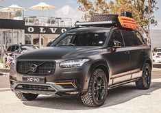 an suv with luggage strapped to the roof