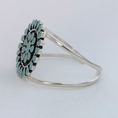 "This stunning Squash Blossom bracelet was handcrafted in Mexico. Each teardrop bezel is inlaid with turquoise coloured enamel enhanced with tiny brown flecks. Surrounding the centre blossom is a woven wire accent. The dimensions of the bracelet are approximately 8\" inches in circumference. This cuff can be adjusted down to 7\" and up to 8.5\" This piece is silver plated. The pattern of the enamel may vary very slightly, they are all individually hand crafted. If you've got any questions don't Southwestern Turquoise Bangle, Southwestern Style Turquoise Cuff Bracelet, Southwestern Style Round Turquoise Cuff Bracelet, Bracelet Mexican, London Market, Turquoise Squash Blossom, Navajo Style, Mexican Jewelry, Squash Blossom