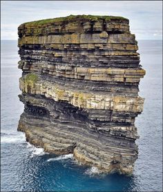 a rock formation in the ocean with an inspirational quote above it that reads, what million years look like in one photo