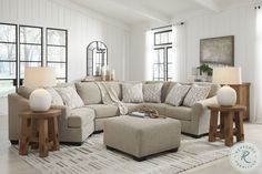 a living room filled with lots of furniture and decor on top of a white rug