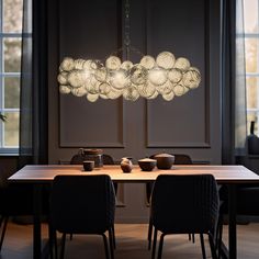 a dining room table with chairs and a chandelier