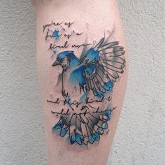 a blue bird with writing on it's leg and some words in the background