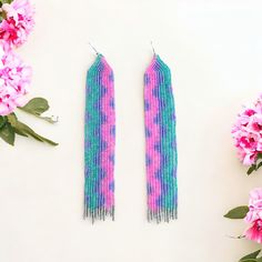 Turquoise Purple And Pink Long Seed Bead Fringe Beaded Earrings Wavy Shimmer Dimensions 5.75”L X 1”W Elevate Your Style With Our Turquoise And Pink Long Seed Bead Fringe Earrings. Adorned With A Colorful Wavy Pattern, These Handwoven Earrings Add A Touch Of Playful Sophistication To Any Outfit. The Shiny Beads In Turquoise, Purple, Pink, And Silver Come Together To Create A Unique And Exclusive Piece That Will Make A Statement Wherever You Go. These Elegant Seed Bead Earrings Are Handwoven With Bohemian Purple Beaded Earrings For Beach, Handmade Purple Beaded Earrings For Beach, Purple Beaded Dangle Earrings For Beach, Purple Dangle Beaded Earrings For Beach, Turquoise Beaded Earrings For Party, Seed Bead Fringe Earrings, Fringe Beaded Earrings, Handwoven Earrings, Bead Fringe Earrings