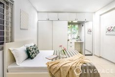 a bed sitting in a bedroom next to a white dresser and window with flowers on it