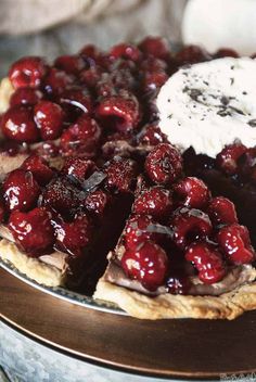 the pie has cherries on it and is ready to be eaten