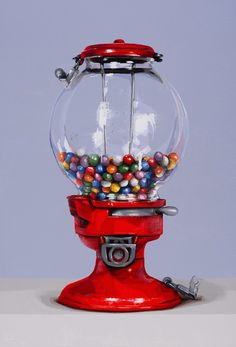 a red gummy machine filled with lots of colorful candies on top of it