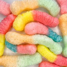 the candy worms are colorfully colored and have been made from sugary marshmallows