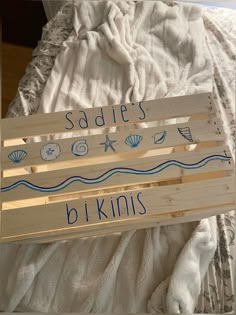 a wooden sign that says sadie's b kinns on the side of a bed