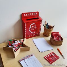 a wooden desk topped with lots of stationery on top of it's table